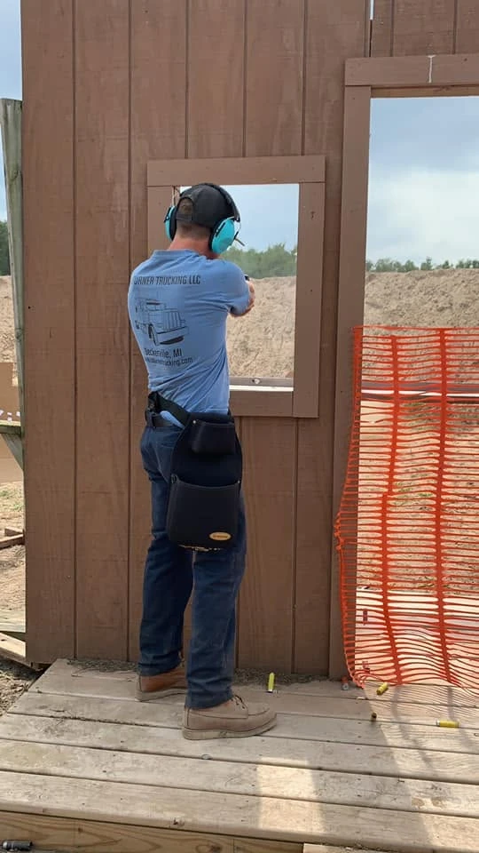 Member shooting through a range bay window